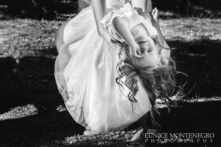 black and white picture of a flower girl hanguing upside down