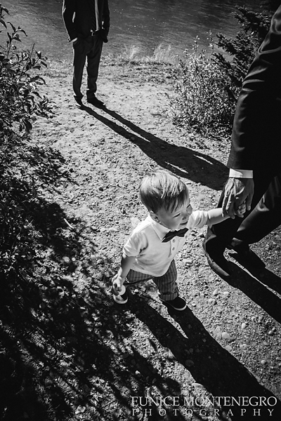 ring bearer holding his father's hand 