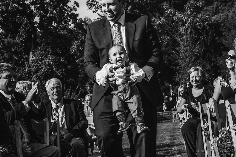 picture of a baby ring bearer being carried down the aisle